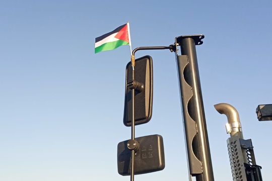 Palestine flag flying from the wing mirror of dockworker's truck Palestine flag flying from the wing mirror of dockworker's truck