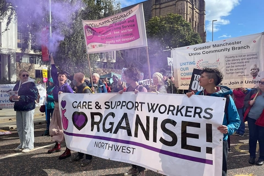 Care and Support Workers Organise members in the North West carrying their banner on a demonstration.