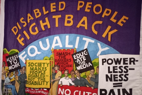Disabled people fightback banner, in traditional trade union banner style.