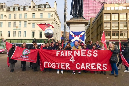 An IWGB foster care workers branch protest in Glasgow, with members holding a banner reading "Fairness 4 Foster Carers"